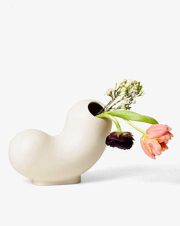 white ceramic curly vase with flower inside