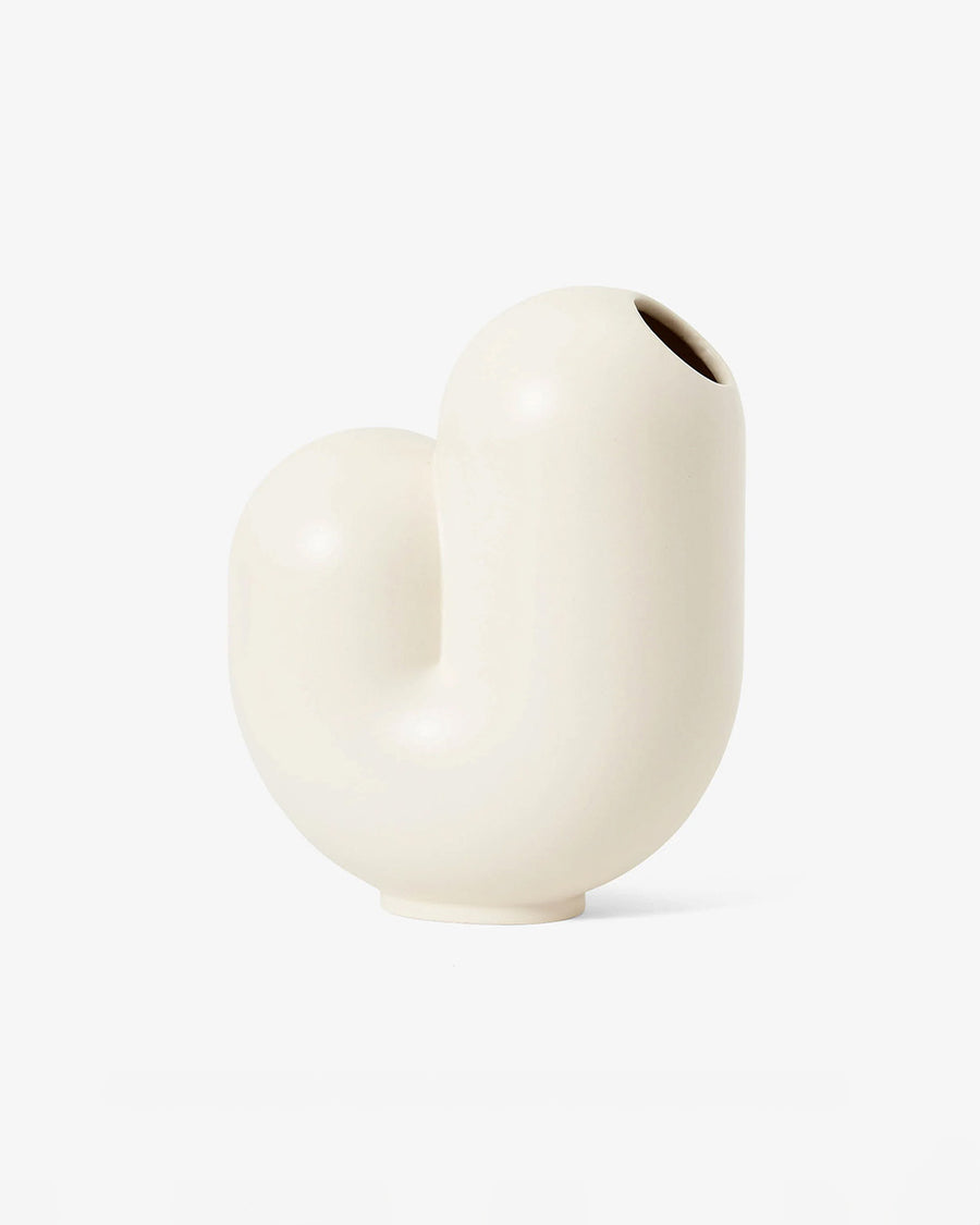 white ceramic vase shaped like a j