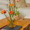 amber cylinder shaped vase on a table