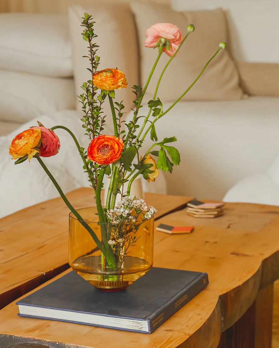 amber cylinder shaped vase on a table