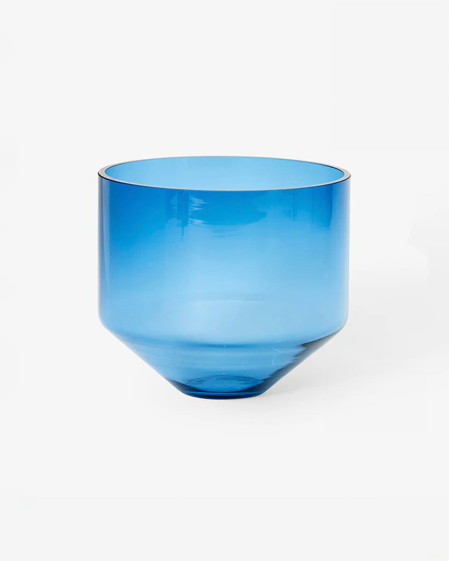 blue cylinder shaped vase with plant inside