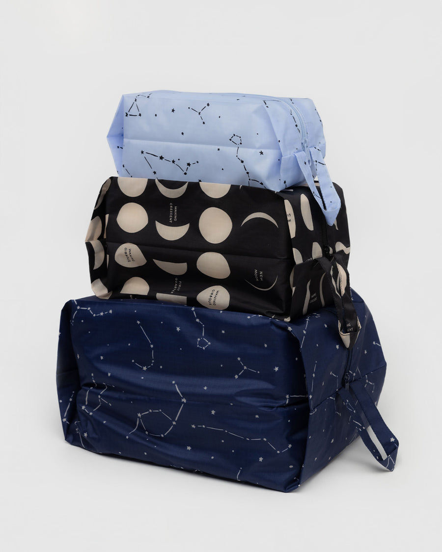 set of three nylon 3d zip set: small light blue constellation, medium black moon phases, and large dark blue constellations