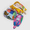 set of three 3d pouches: small pink abstract fruit, medium light blue cats, and large yellow cakes filled with items