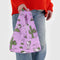 model holding purple baby baggu with peanuts spike and cactus print