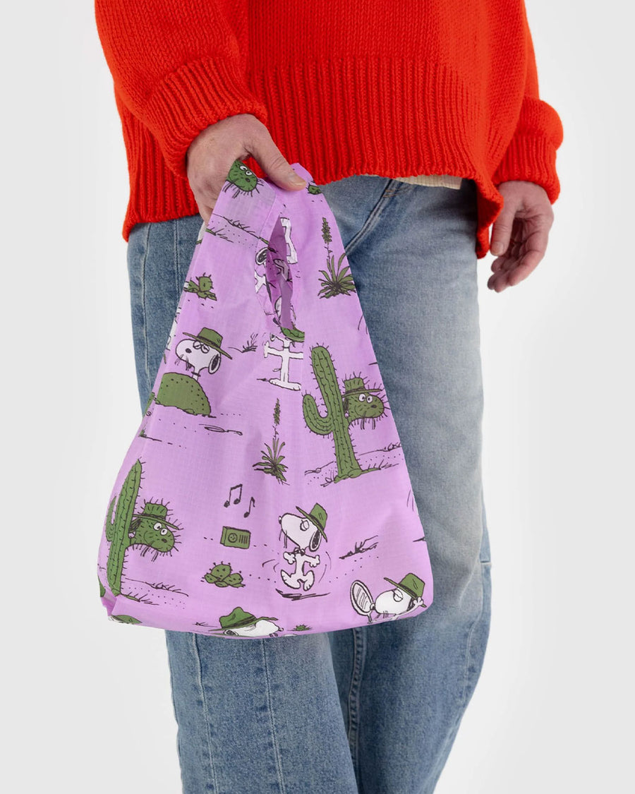 model holding purple baby baggu with peanuts spike and cactus print