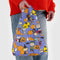 model holding blue baby baggu with the peanuts characters dress in various halloween costumes and surrounded by pumpkins/jack o'lanterns