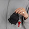 model holding black mini baggu backpack keychain