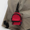 candy apple mini baggu backpack keychain with black trim on a backpack