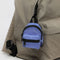 cornflower mini baggu backpack keychain with black trim clipped onto a backpack