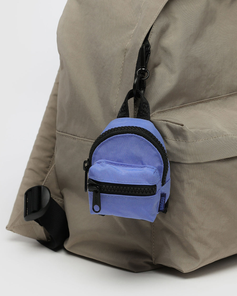 cornflower mini baggu backpack keychain with black trim clipped onto a backpack