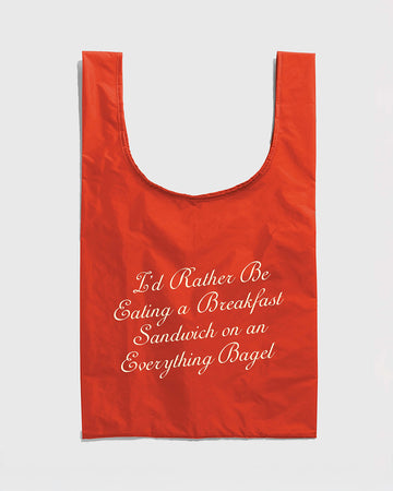 red standard baggu with white 'i'd rather be eating a breakfast sandwich on an everything bagel'