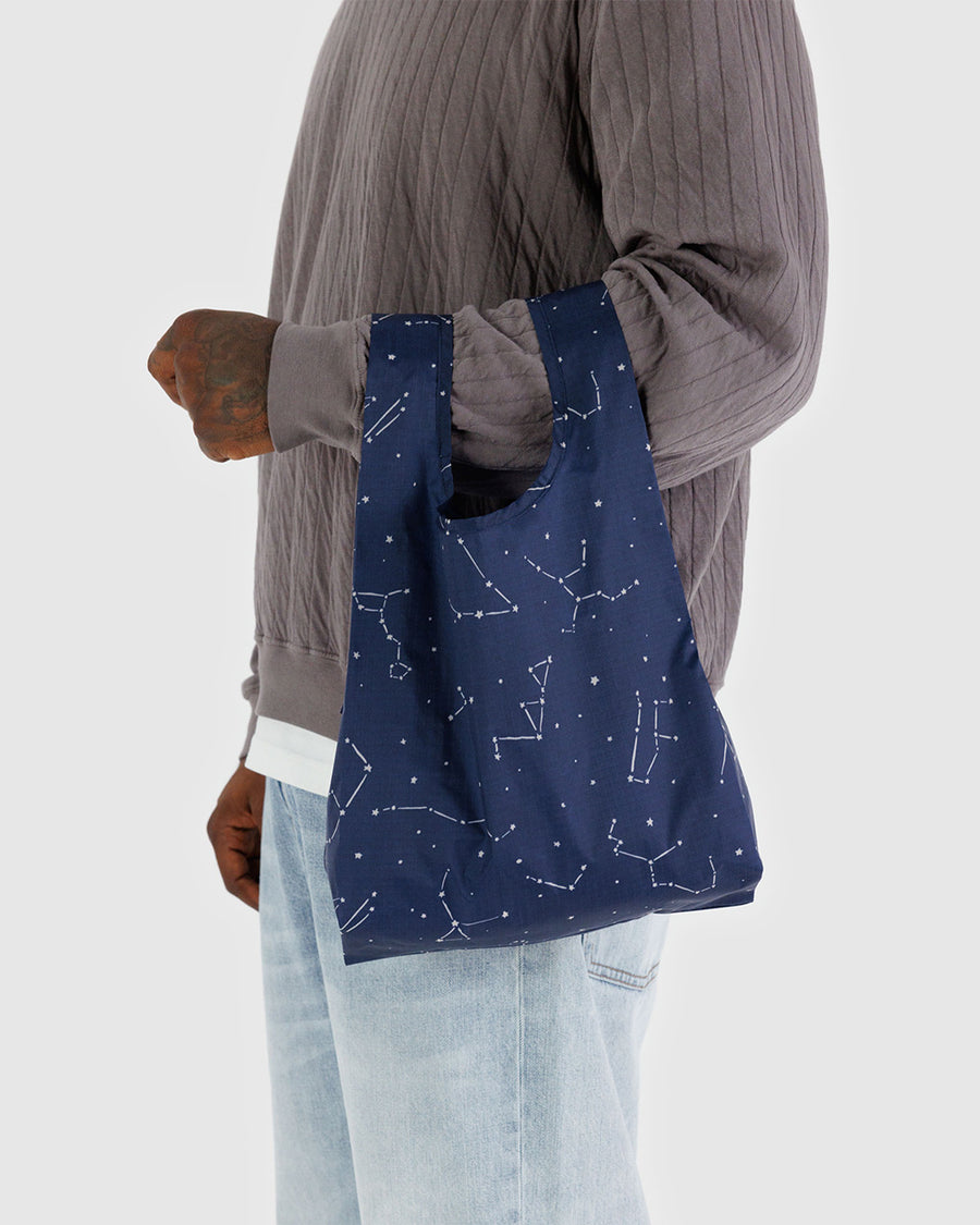 model holding navy baby baggu with white constellation print