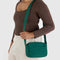 model carrying jewel tone green camera crossbody with matching green strap