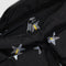 up close of black cargo shoulder bag with silver metallic star print