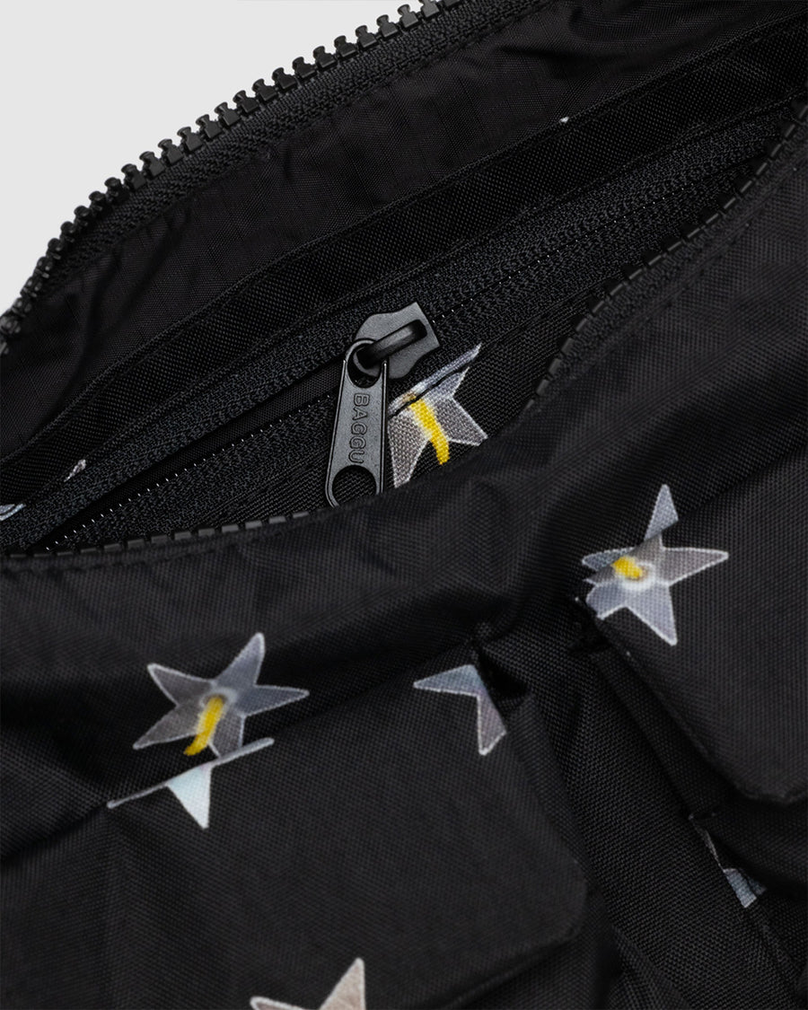 up close of black cargo shoulder bag with silver metallic star print