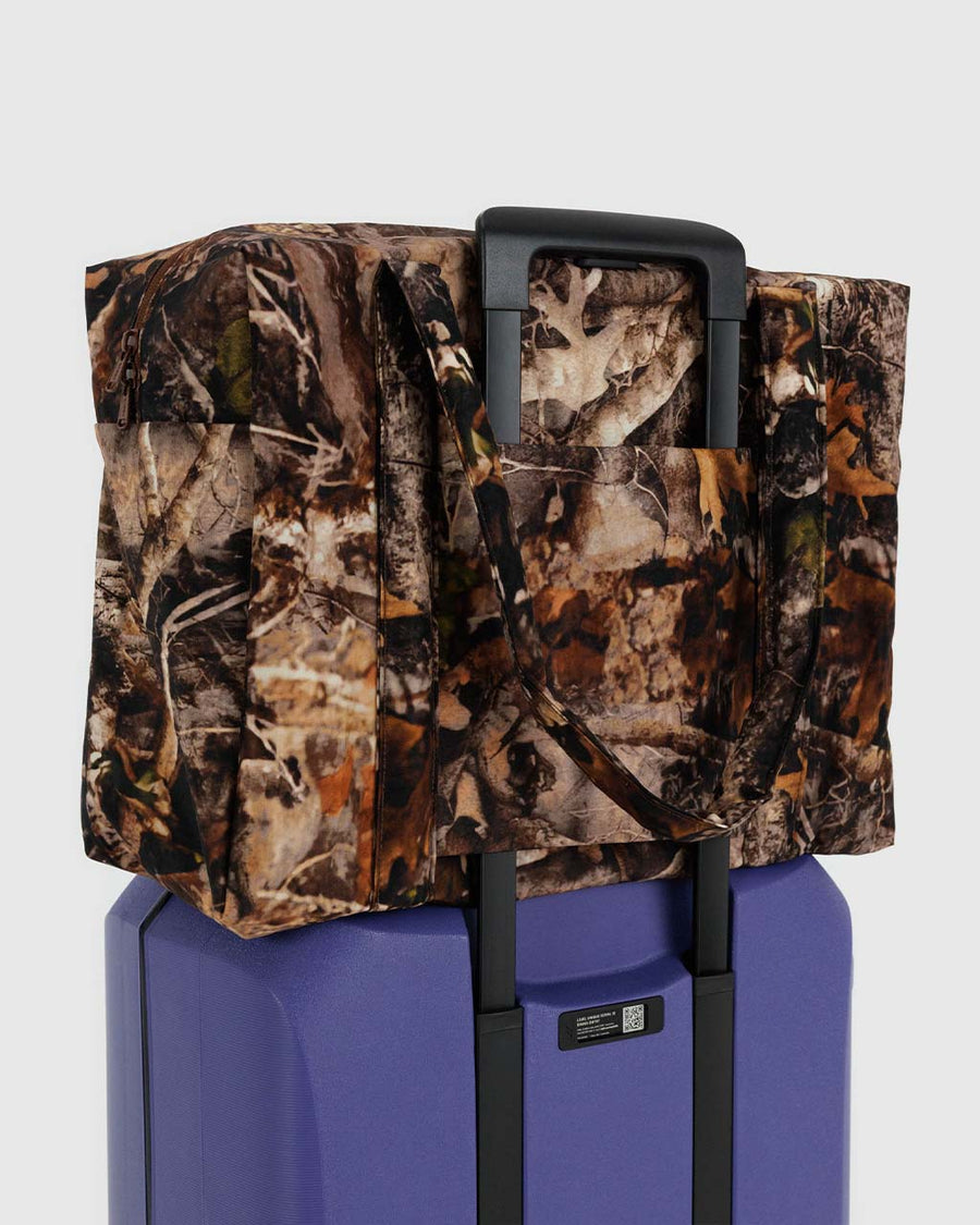 realistic tree branch and fall leaves cloud carry-on bag on suitcase