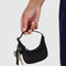 model holding black bag charm keychain