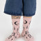 model wearing pink socks with black ballet icons print