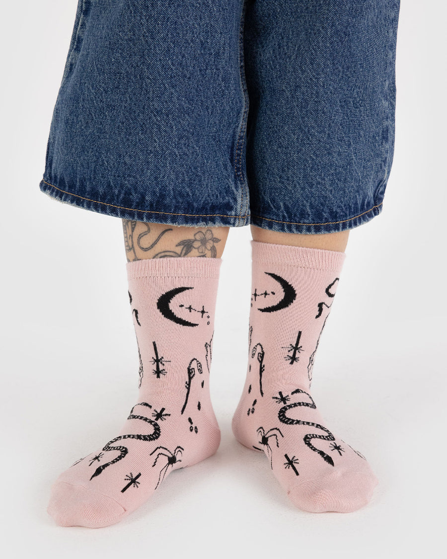 model wearing pink socks with black ballet icons print