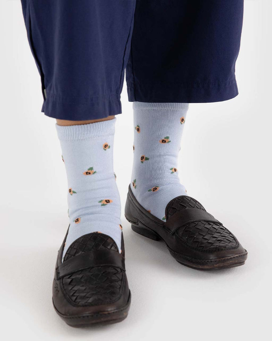 model wearing blue crew socks with dainty yellow floral design