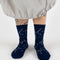 model wearing dark blue crew socks with white constellation print