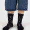 model wearing black crew socks with white moon phase print