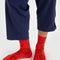 model wearing red crew socks with all over brown smiley face print