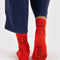 back view ofr red crew socks with all over brown smiley face print