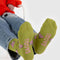 bottom of avocado green crew socks with snoopy in a pink puffer coat