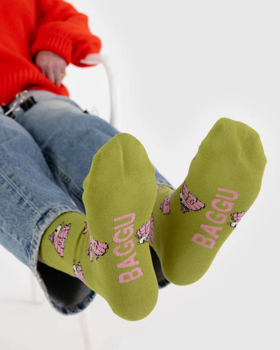 bottom of avocado green crew socks with snoopy in a pink puffer coat