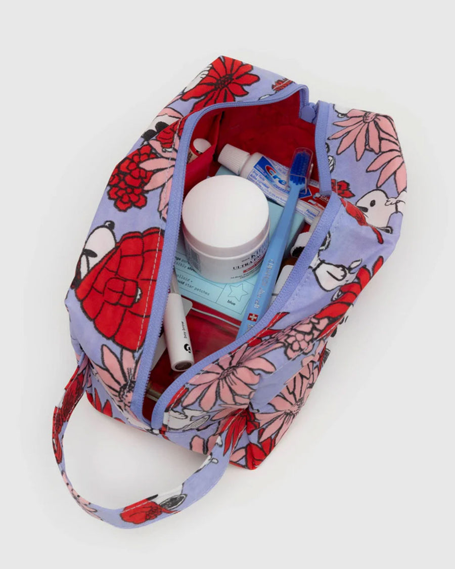 items inside of lavender dopp kit with snoopy and floral print