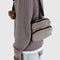 model wearing taupe fanny pack with black adjustable strap