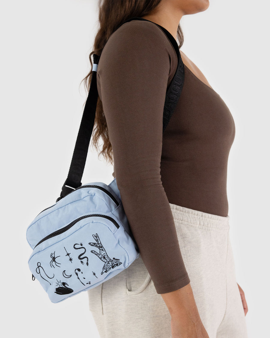 model wearing light blue fanny pack with black embroidered ballet icons