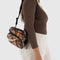 model wearing realistic tree and leaf print fanny pack with black adjustable strap