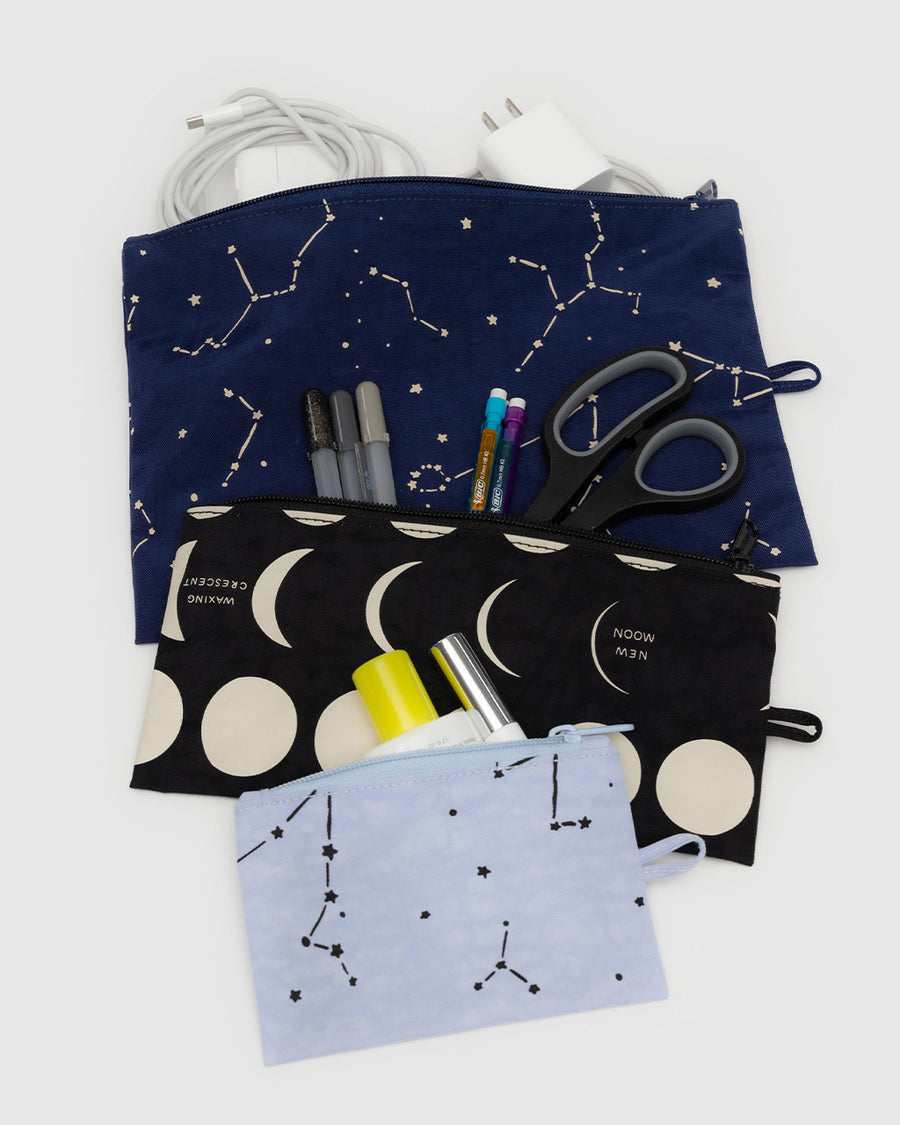 set of three flat pouch set: light blue constellation, black moon phases and navy constellation filled with items