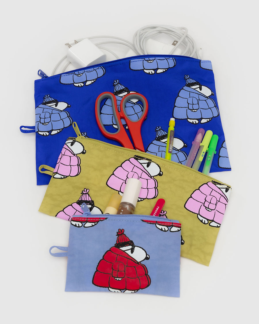 set of three flat pouch set: red snoopy puffer, pink snoopy puffer, and blue snoopy puffer filled with items