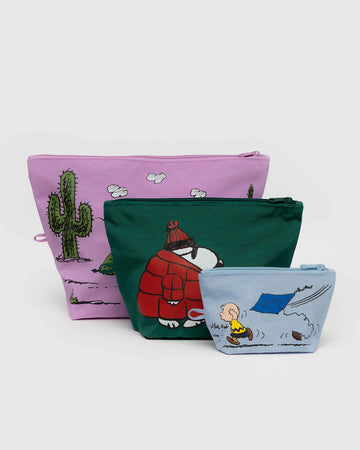 set of three peanuts go pouch set: light blue charlie kite, medium: green snoopy in a puffer coat, and large: pink desert spike print