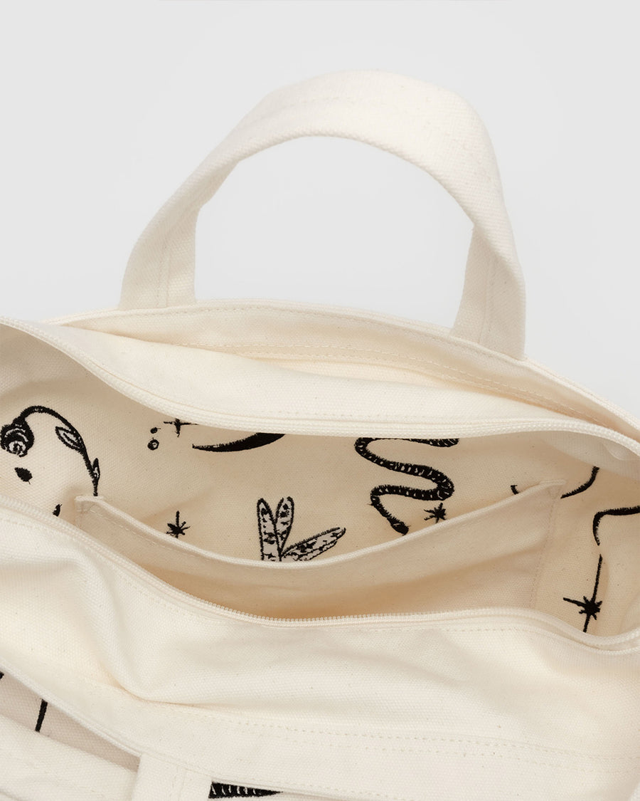 interior of cream horiztonal zip bag with black embroidered ballet icons design