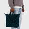 model holding navy and dark green horizontal zip duck bag