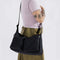 model wearing black large cargo crossbody bag