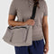 model wearing taupe cargo crossbody with two large zipper pockets in the front