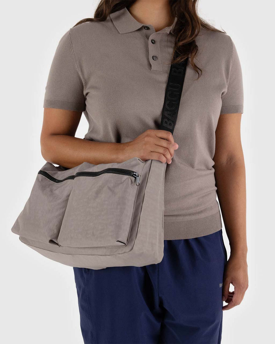 model wearing taupe cargo crossbody with two large zipper pockets in the front