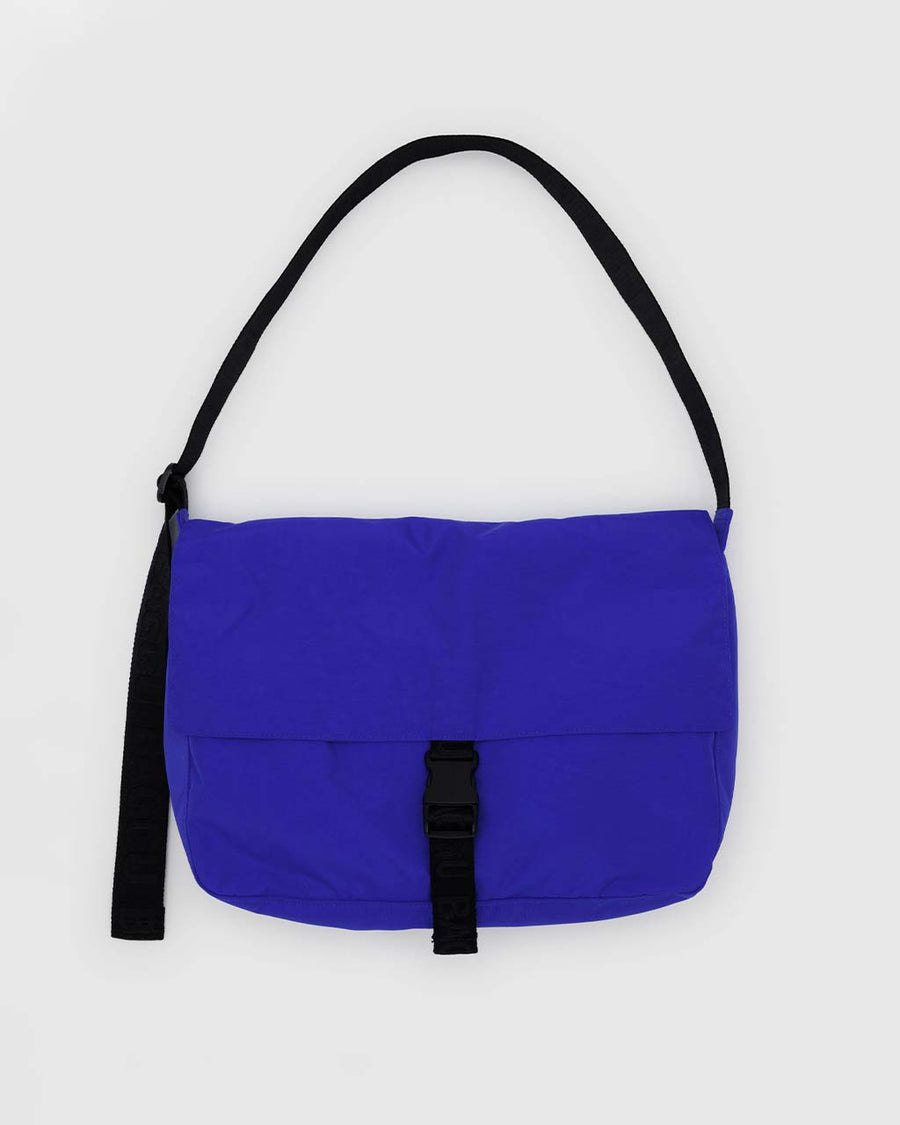 bright blue large messenger bag with black strap and closure 