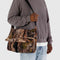 model holding photo forest large messenger bag with black strap and closure 