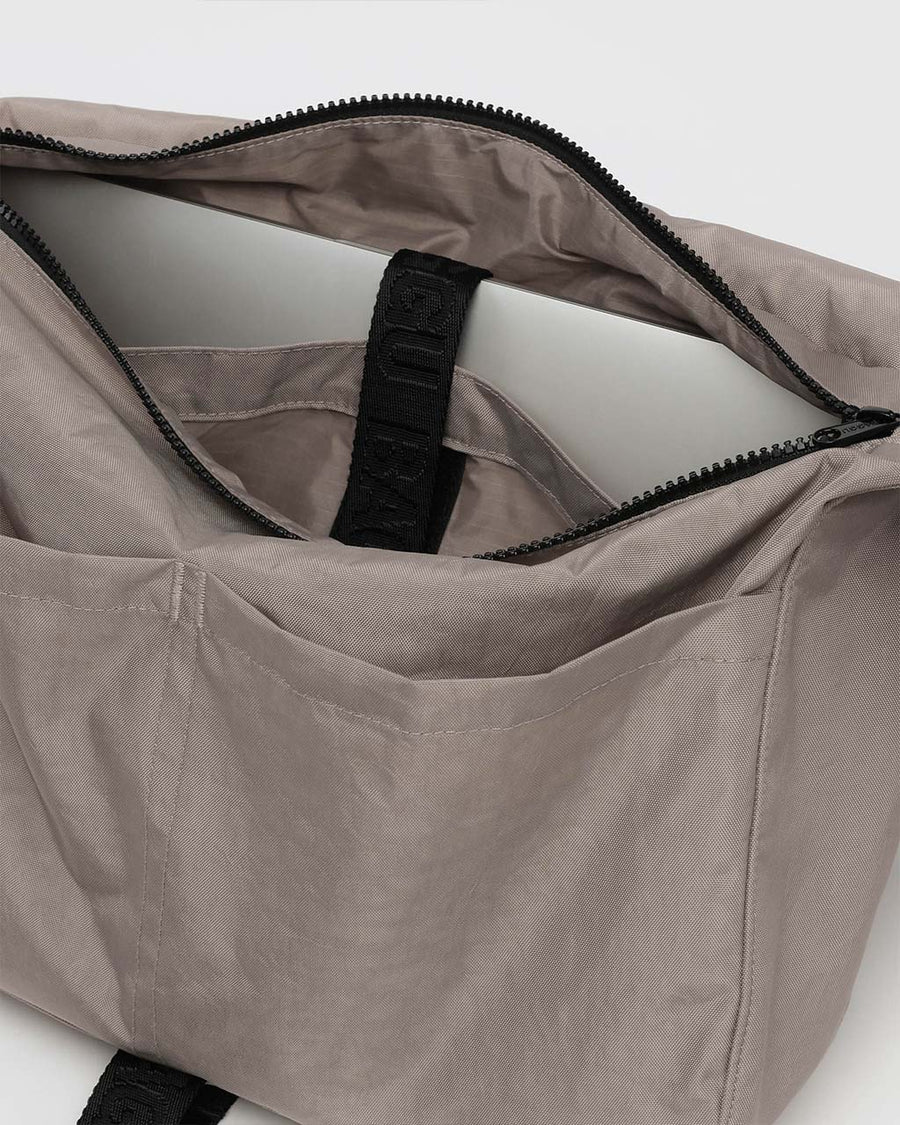 inside of taupe large messenger bag with black strap and closure 