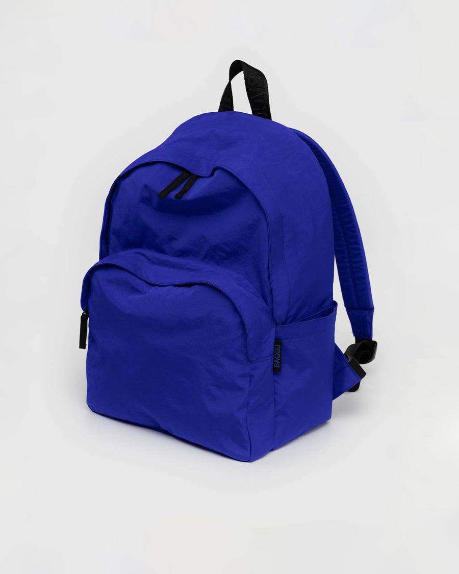 large bright blue nylon backpack with two front zipper compartments and drink holder on the side