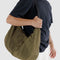 model wearing dark green large crescent baggu bag