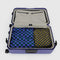 set of two large packing cubes: olive/navy checker and bright blue/dark green checker inside a suitcase