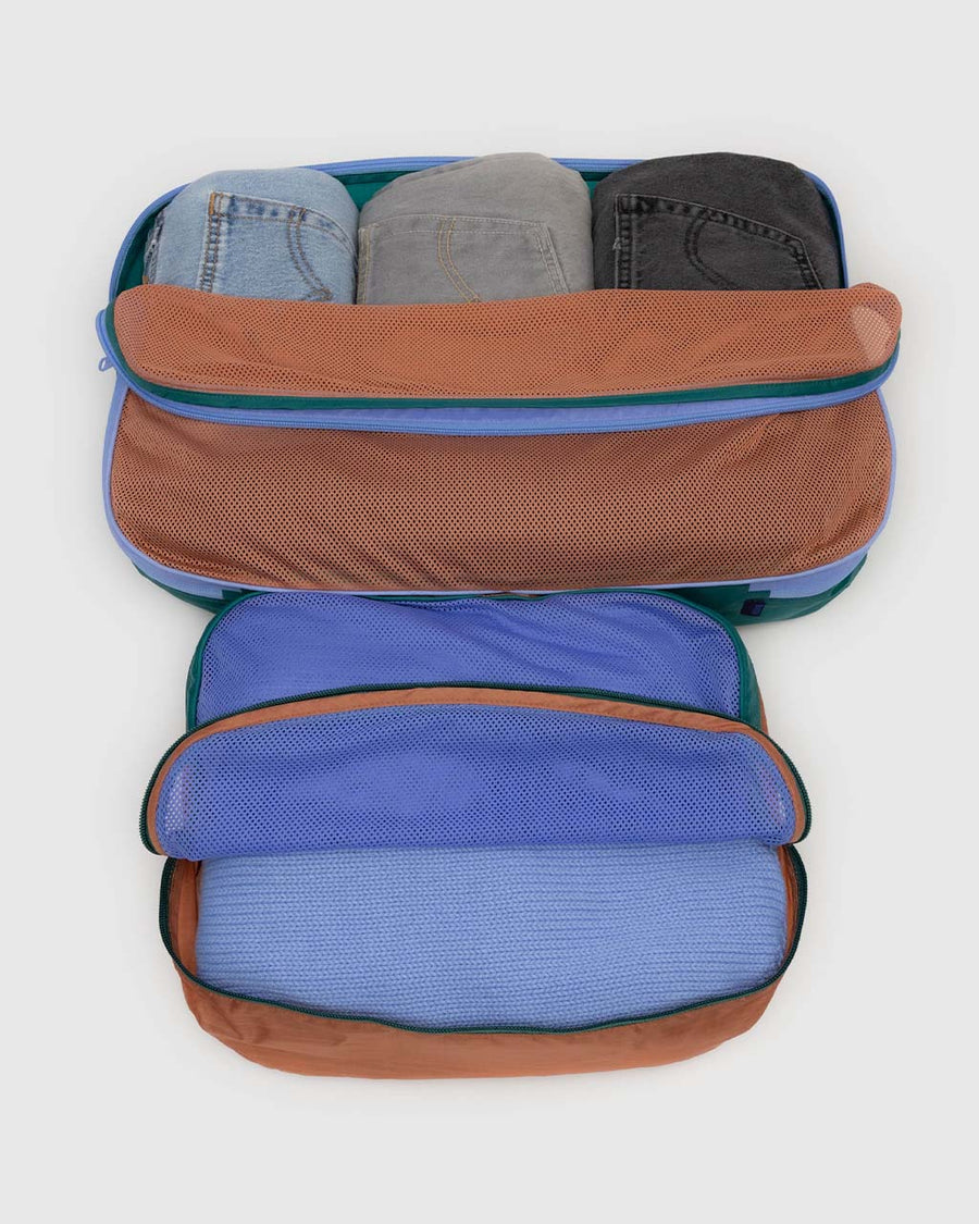 items inside of set of two large packing cubes: cornflower, terracotta, and dark green color block