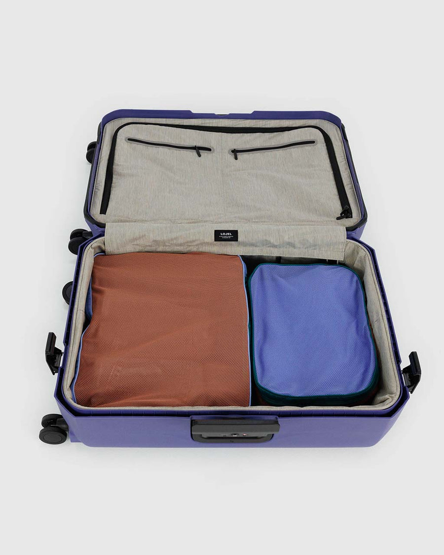 set of two large packing cubes: cornflower, terracotta, and dark green color block inside suitcase